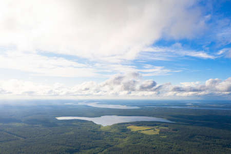 Aerial view clouds over the forest and lake. View from drone. Aerial top view cloudscape. Texture of clouds. View from above. Sunrise or sunset over cloudsの写真素材