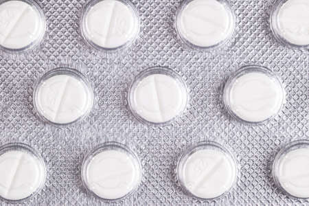 Macro shot pile of tablets pill in blister packaging. Silver aluminium foil blister pack....
