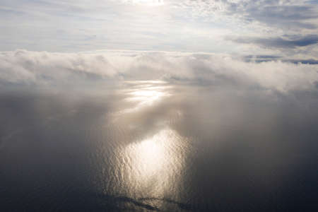 Aerial view clouds over the sea. View from drone. Aerial top view cloudscape. Texture of clouds. View from above. Sunrise or sunset over clouds. Aerial ocean backgroundの写真素材