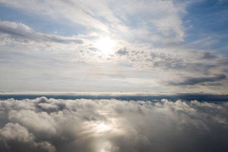 Aerial view clouds over the sea. View from drone. Aerial top view cloudscape. Texture of clouds. View from above. Sunrise or sunset over clouds. Aerial ocean backgroundの写真素材