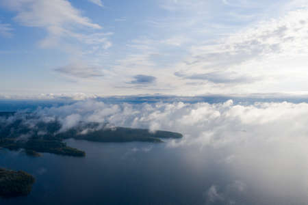 Aerial view clouds over the sea. View seashore and coastline from drone. Aerial top view cloudscape. Texture of clouds. View from above. Sunrise or sunset over clouds. Aerial ocean backgroundの写真素材