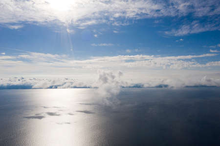 Aerial view clouds over the sea. View from drone. Aerial top view cloudscape. Texture of clouds. View from above. Sunrise or sunset over clouds. Aerial ocean backgroundの写真素材