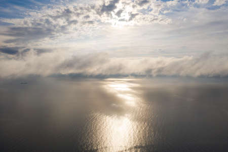 Aerial view clouds over the sea. View from drone. Aerial top view cloudscape. Texture of clouds. View from above. Sunrise or sunset over clouds. Aerial ocean backgroundの写真素材