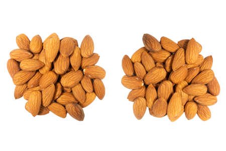 Almond background close up isolated on white background.. Macro shot fresh almonds nutsisolated over white  . Almond texture closeup. Almond heap texture background.の写真素材