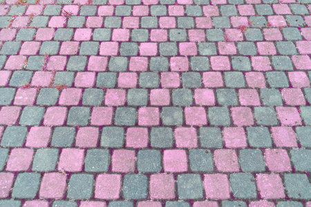Sidewalk tiles. Closeup of paving slabs background. Street paving slabs. Cement block of the road. Cement brick squared stone floor background.の写真素材