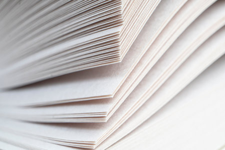 Macro shot of open book. Education and study concept. Close-up of opened book pages. Macro view of book pages. Edges of open paper book sheets close-upの写真素材