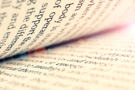 Macro shot of open book. Education and study concept. Close-up of opened book pages. Macro view of book pages. Edges of open paper book sheets close-upの写真素材