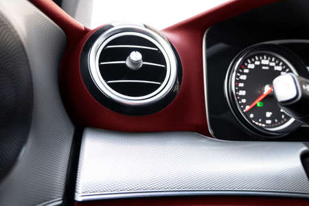 AC ventilation deck in luxury modern car Interior. Modern car red leather interior. Natural carbon...