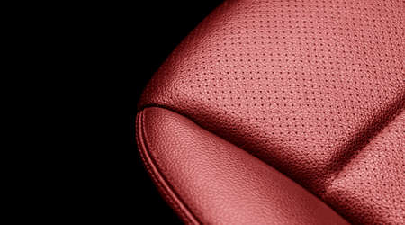 Modern luxury car red leather interior. Part of red leather car seat details with stitching. Interior of prestige car. Comfortable perforated leather seats. Perforated leather.の写真素材