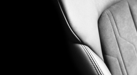 Modern luxury car black leather with alcantara interior. Part of black leather car seat details with...