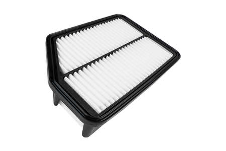 New car air filter element. Car engine air filter isolated on white background. Close-up air filter isolated. Quality spare parts for car service or maintenanceの写真素材