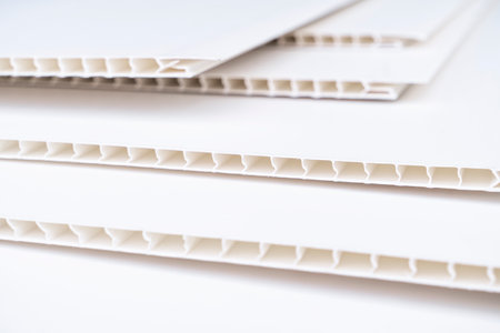 Construction vinyl siding panels pattern. House covered with white plastic vinyl siding. Vinyl...