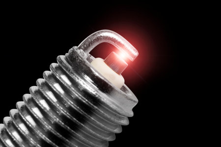 Macro shot of sparks on spark plug isolated on black background. A spark plug for an engine isolated...