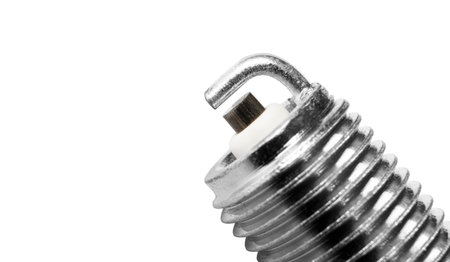 Macro shot spark plug isolated on white background. A spark plug for an engine isolated with clipping path. Quality spare parts for car service or maintenanceの写真素材