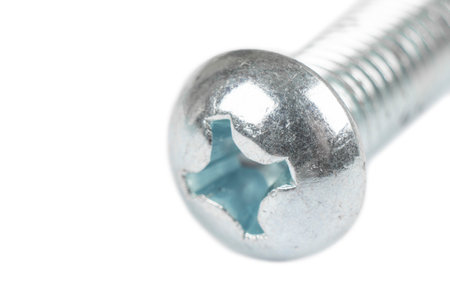 Macro shot metal bolt isolated on white background. Chromed screw bolt isolated. Steel bolt isolated. Nuts and bolts. Tools for work.の写真素材