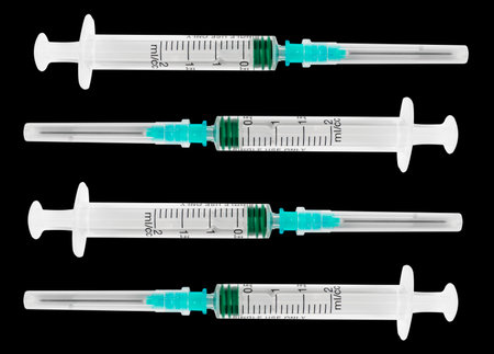 Empty syringe close up isolated on black background. Vaccine plastic hypodermic syringe. Close-up of medical syringe. Syringe for injection and vaccination solution.の写真素材