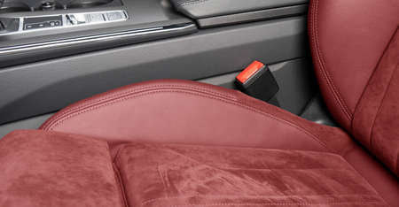 Red luxury modern car Interior. Steering wheel, shift lever and dashboard. Detail of modern car...