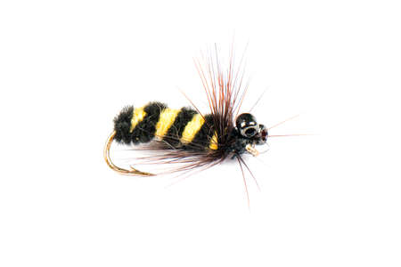 Macro shot colorful fishing fly isolated on a white background. Hand made fly fishing flies. Fluffy...