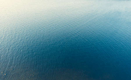 Aerial view of a crystal clear sea water texture. Top view from above. Natural blue background. Blue water reflection. Blue ocean wave. Summer sea. Drone. Top viewの写真素材