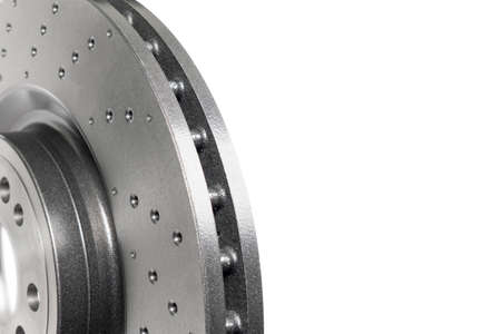Car brake disc isolated on white background. Auto spare parts. Perforated brake disc rotor isolated...
