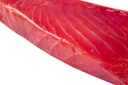 Yellow fin tuna steak isolated on white background. Fresh rare tuna steak isolated on white. Raw yellowfin tuna fillet texture. Background fresh tuna meat. Top view of slices of tuna meat.の写真素材