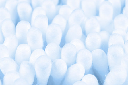 Macro shot set of cotton buds. Cotton buds background. White soft cotton swabs for make up or cosmetics and ear cleaning. Medical plastic sticks signsの写真素材