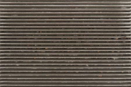 Used car cabin charcoal air filter texture background. Dirty carbon car air filter with dust...