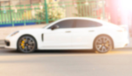 Blurred background with cars on the street. Bokeh lights background. Abstract blur car parking lot...