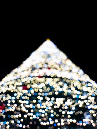 Blurry illuminated christmas tree. Abstract blurred christmas tree with blue lights. Atmospheric...