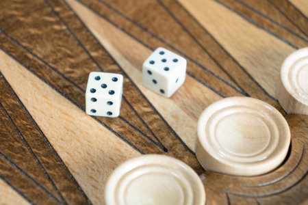 Closeup of backgammon board game. Wooden backgammon board with checkers and dice pairの写真素材