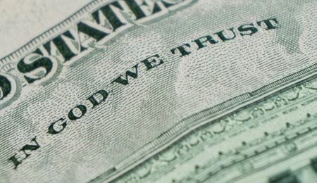 Macro shot image of the phrase in god we trust. Concept of financial success. Background of 5 dollar...