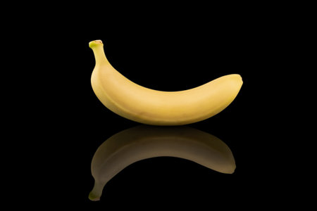 solated bananas. Banana fruit isolated on black mirror background. Ripe bananas with clipping path. Banana fruit close up. Banana isolatedの写真素材