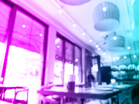 Cafe restaurant interior with customer and wood table blur abstract background with bokeh light. Blue and pink tonesの写真素材