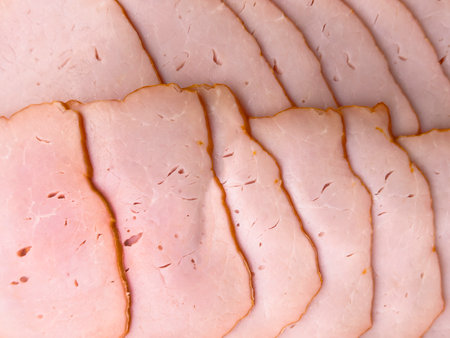 Top view of sliced smoked beef meat background. Raw beef ham isolated over white