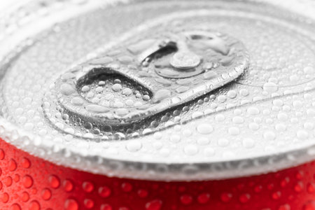 Red aluminum cans with fresh water drops texture background. Water droplets on soda can macro shotの写真素材
