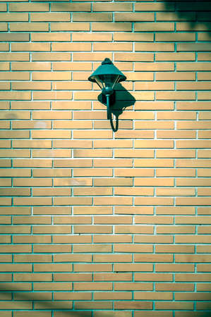 Brick wall with a lamp free space for textの写真素材