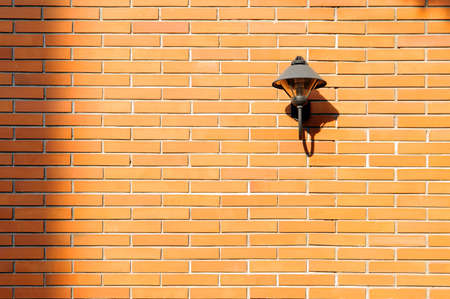 Brick wall with a lamp free space for textの写真素材