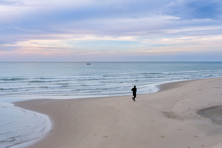 silhouette of man jogging on the beachの写真素材