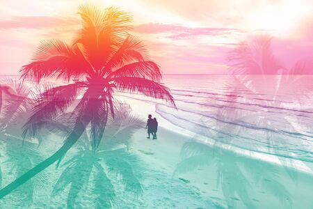 Silhouette of young couple on the beachの写真素材