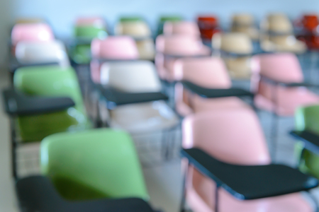 Abstract blurred image of  Many lecture chairs arranged neatly in empty classroom.の写真素材