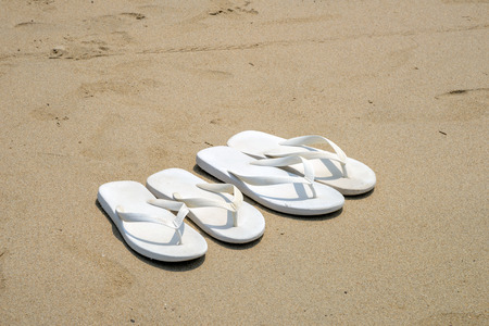 White flip flops on a beachの写真素材