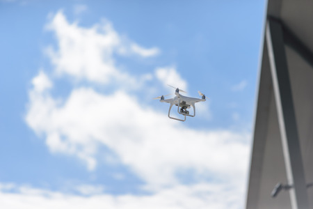 drone hovering in blue sky