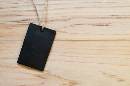 Blank label (tag) on wooded background with copy space. Price tag, gift tag, sale tag, address labelの写真素材