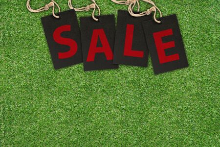 Sale Tags on Green Grass with copy spaceの写真素材