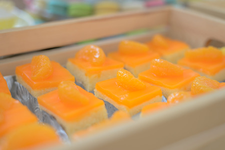 piece of orange cake in wooden box at the partyの写真素材