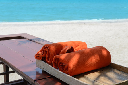 orange towels in wooden box near beach. vacation conceptの写真素材
