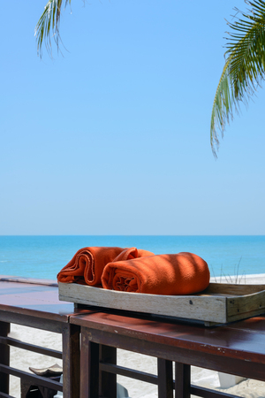 orange towels in wooden box near beach. vacation conceptの写真素材