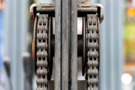 Close up of machine engine chain with cog wheel part of forklift truck