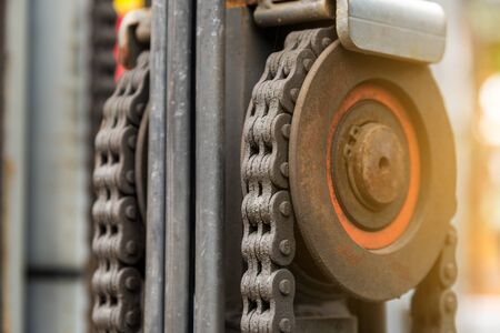 Close up of machine engine chain with cog wheel part of forklift truckの写真素材