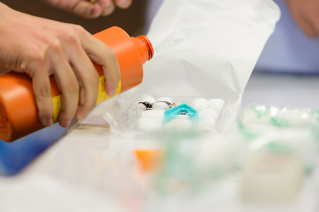 pouring normal iodine into medical nursing setの写真素材